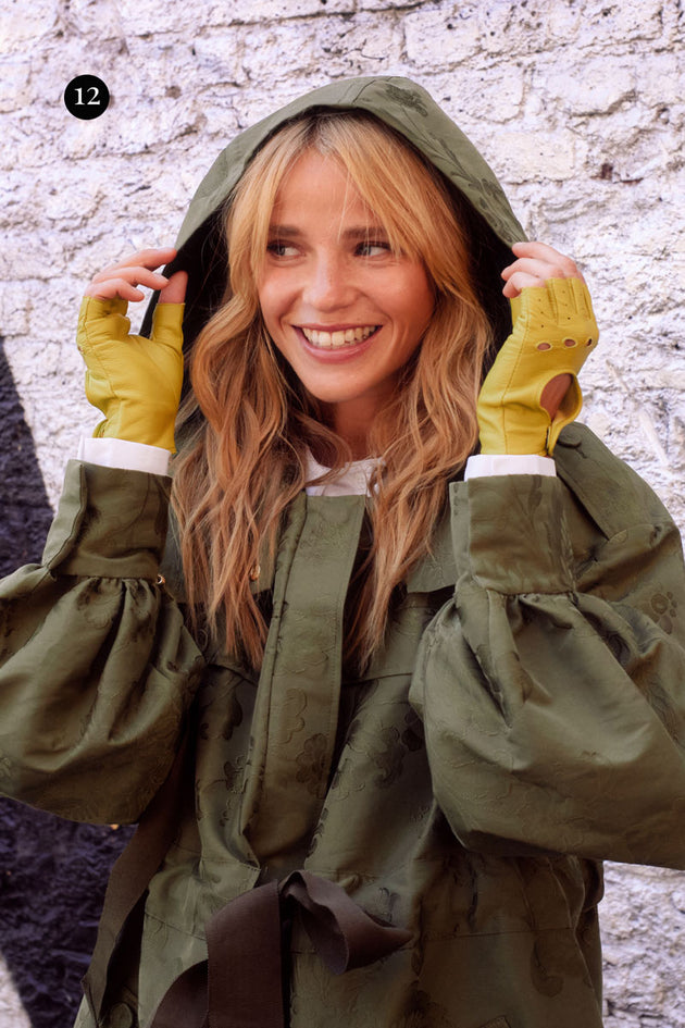 Woman wearing fingerless leather driving gloves in lime in the city