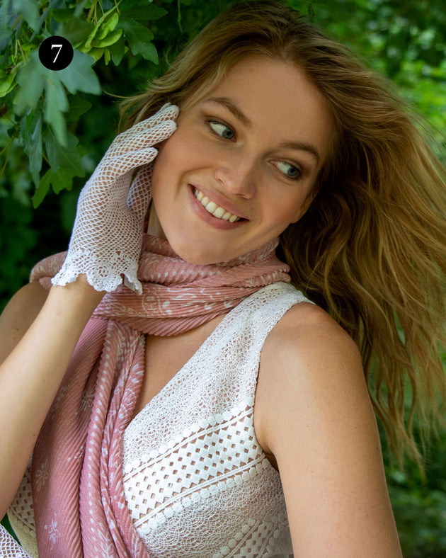 Woman wearing floral lightweight scarf in pale pink at the park