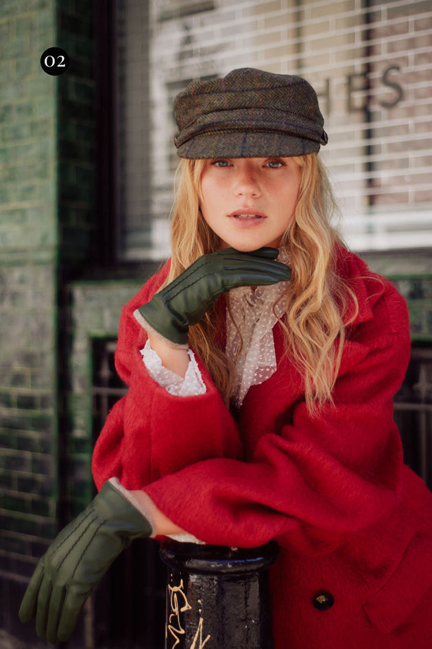 Woman wearing leather gloves in sage