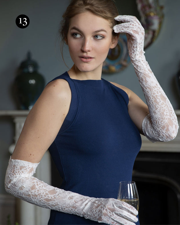 Woman wearing long lace gloves in white at an event
