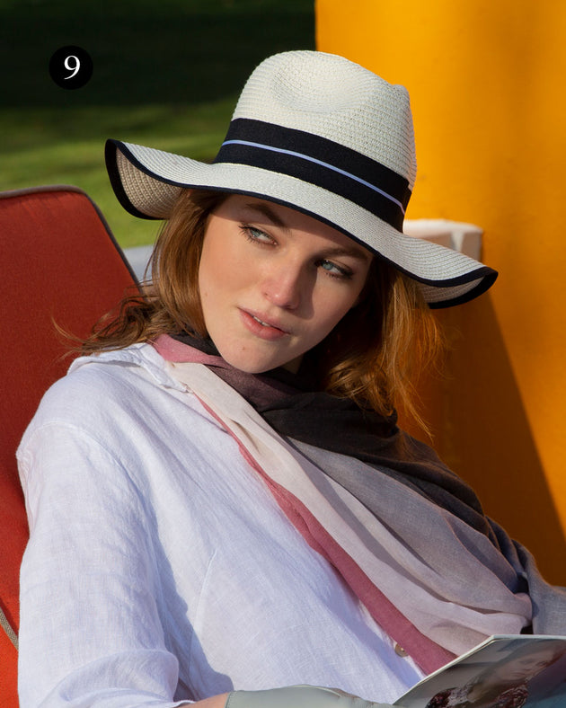 Woman wearing ombre lightweight scarf in pale pink whilst on holiday