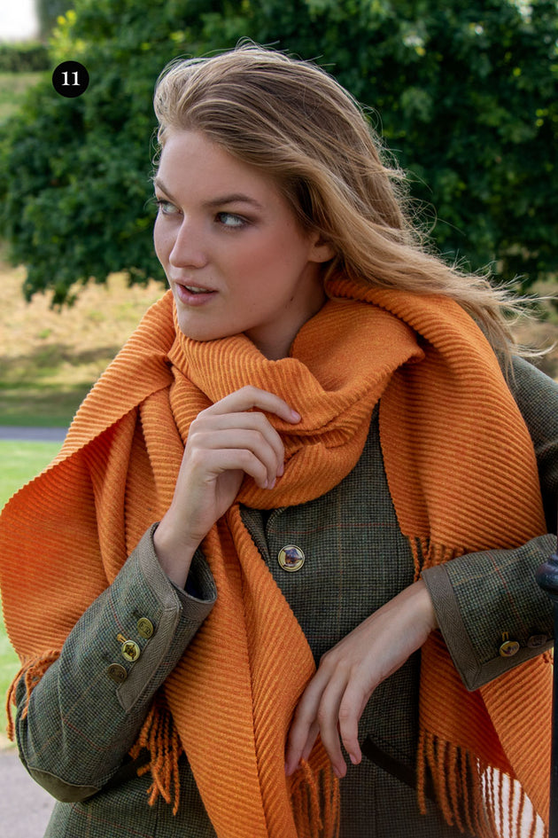 Woman wearing pleated scarf in burnt orange in the park