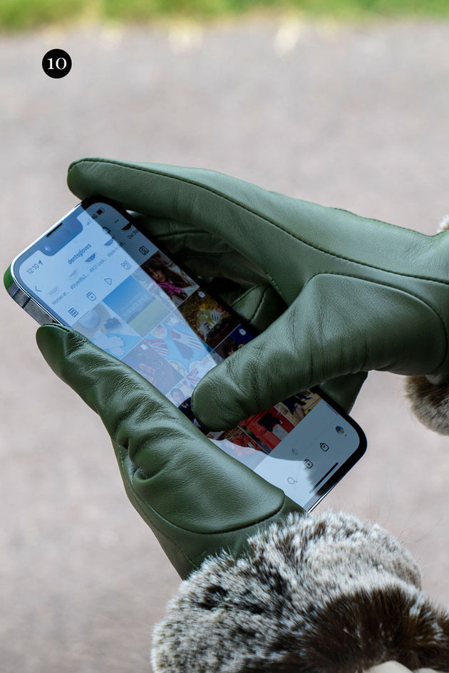 Women's touchscreen gloves with faux fur cuffs scrolling on social media