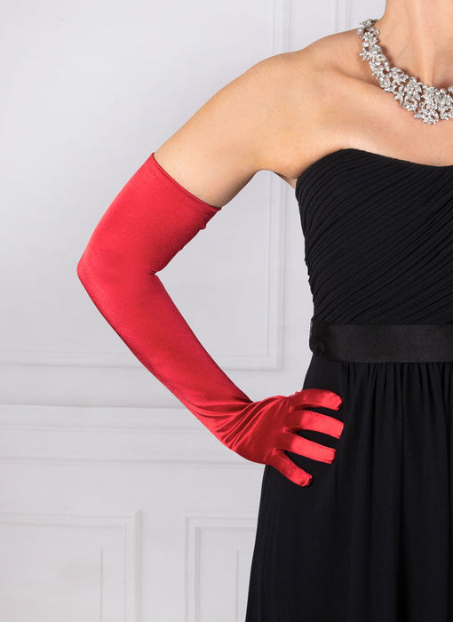 Woman wearing berry red opera satin gloves with an evening dress