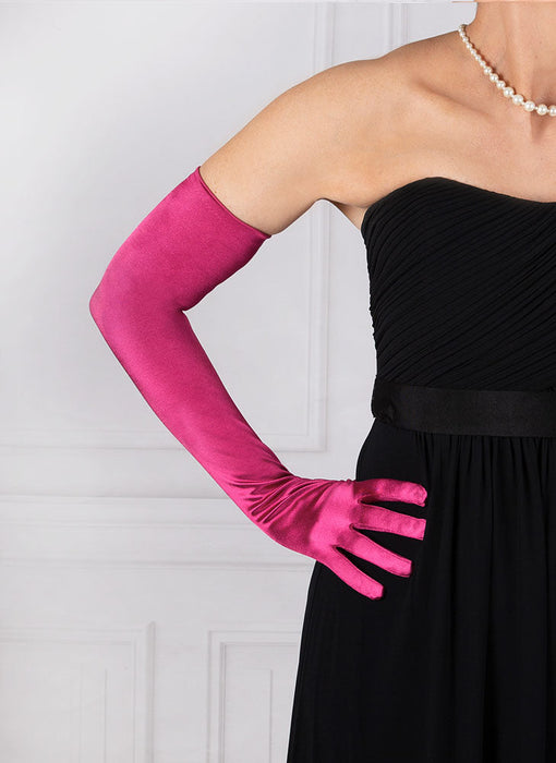 Woman wearing fuchsia pink opera satin gloves with an evening dress