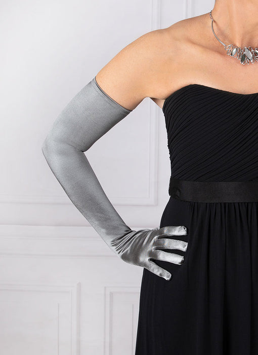 Woman wearing pewter grey opera satin gloves with an evening dress