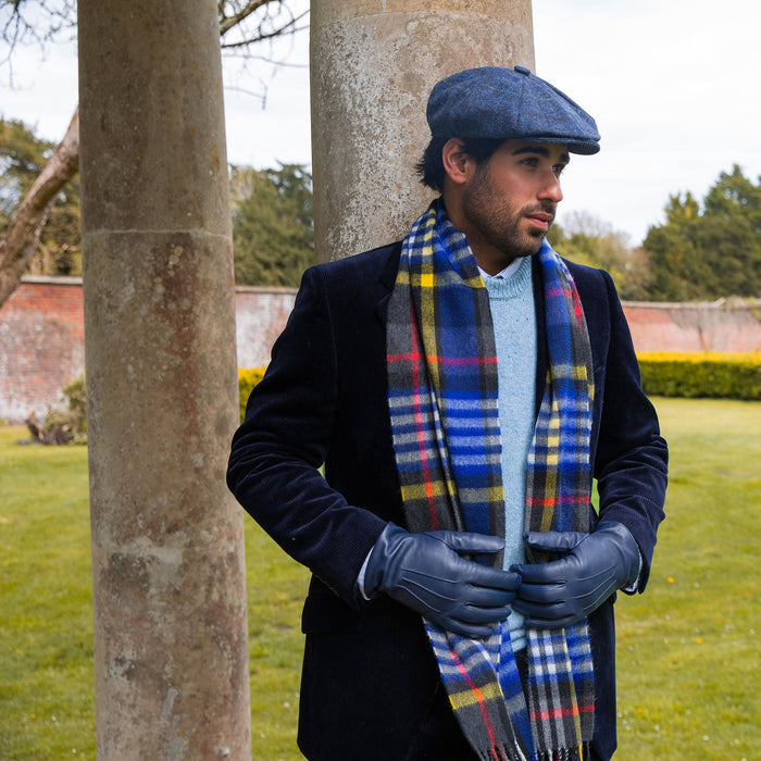 Man wearing cashmere scarf in night sky with tweed hat and leather gloves
