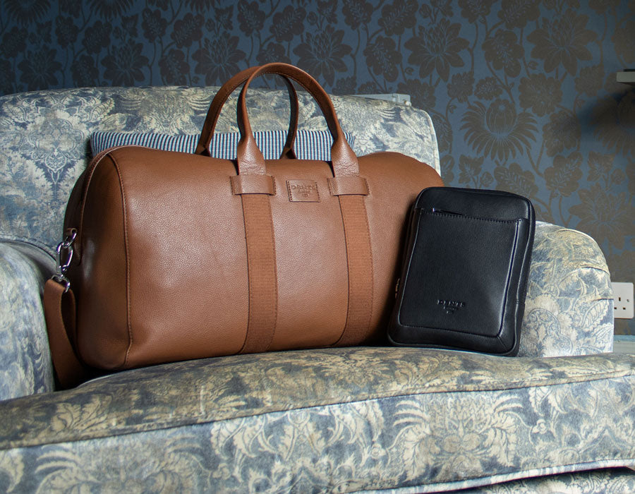 Mens leather bags placed a sofa chair in a hotel room