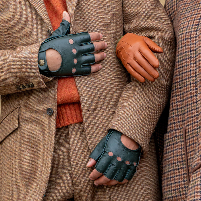 Man wearing fingerless leather driving gloves in british racing green with a tweed jacket
