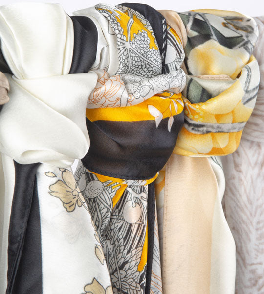 Women's new summer lightweight scarves in various colours hanging down 