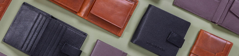 Men's leather wallets with personalisation on a green background