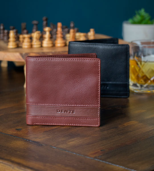Men's leather wallets in two colours laid out on the table
