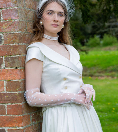 Woman wearing white tulle long gloves with a wedding outfit