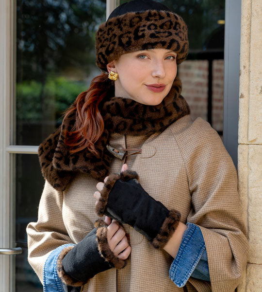 Woman wearing animal print matching set including gloves, hats and scarves outdoors