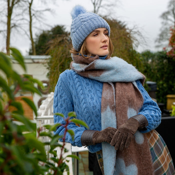 Woman wearing Pale Blue Reversible Floral Blanket Scarf with Tassels in a park