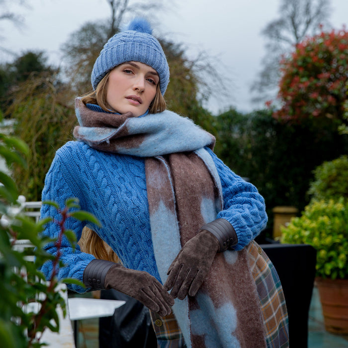 Woman wearing Pale Blue Reversible Floral Blanket Scarf with Tassels in a park