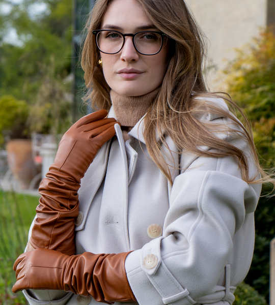 Woman wearing long leather gloves in cognac