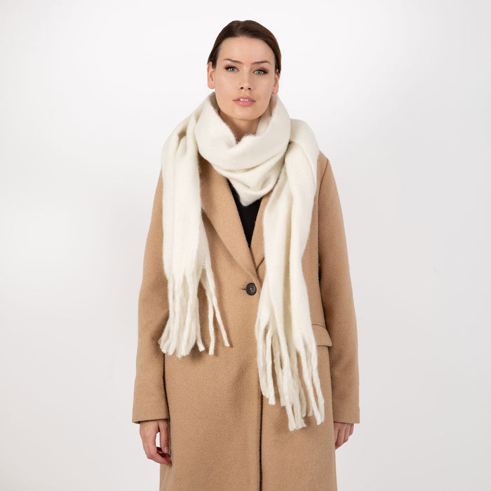 Women's blanket scarf with tassels in ivory wrapped around the neck