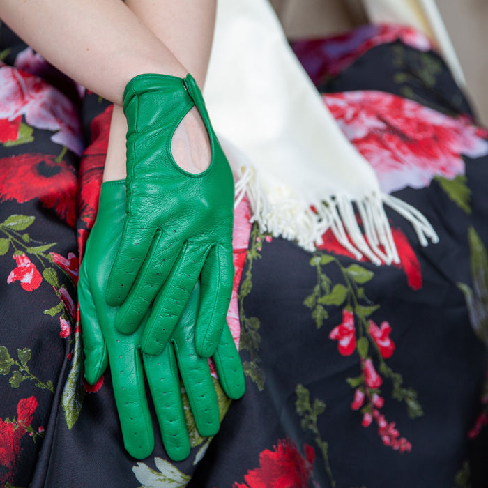 Woman wearing leather driving gloves in emerald