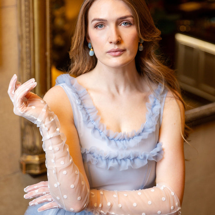 Woman wearing long opera spotty tulle gloves in ivory