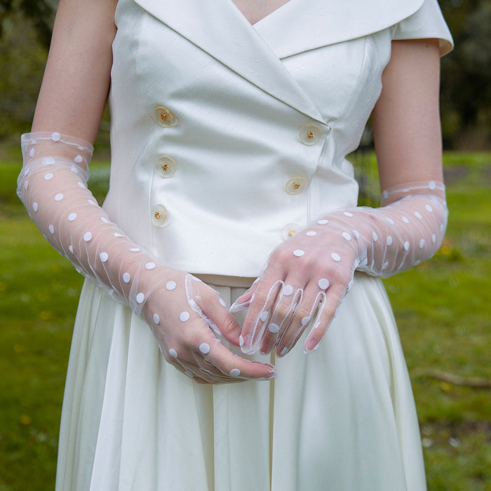 Woman wearing long opera spotty tulle gloves in ivory
