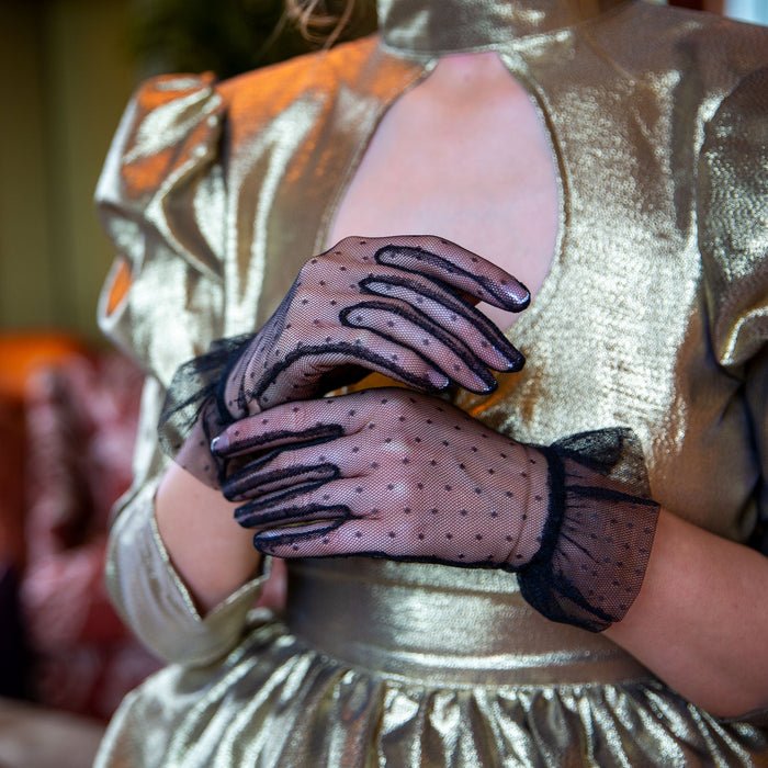 Woman wearing tulle gloves with frilled cuffs in black