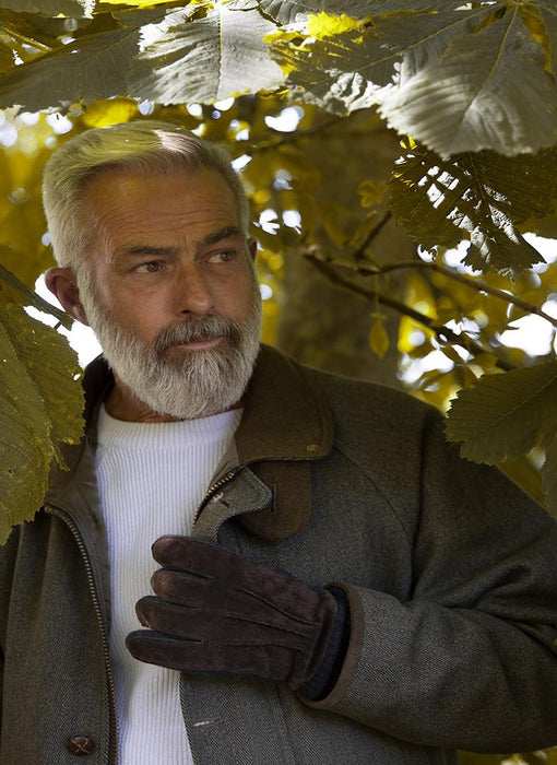 Man wearing Men's Three Point Fleece Lined Suede Gloves Brown Charcoal in the park