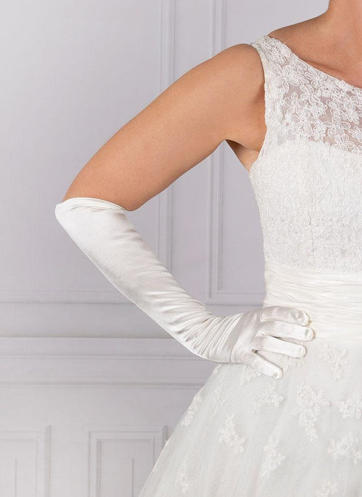 Woman wearing elbow length satin gloves in white